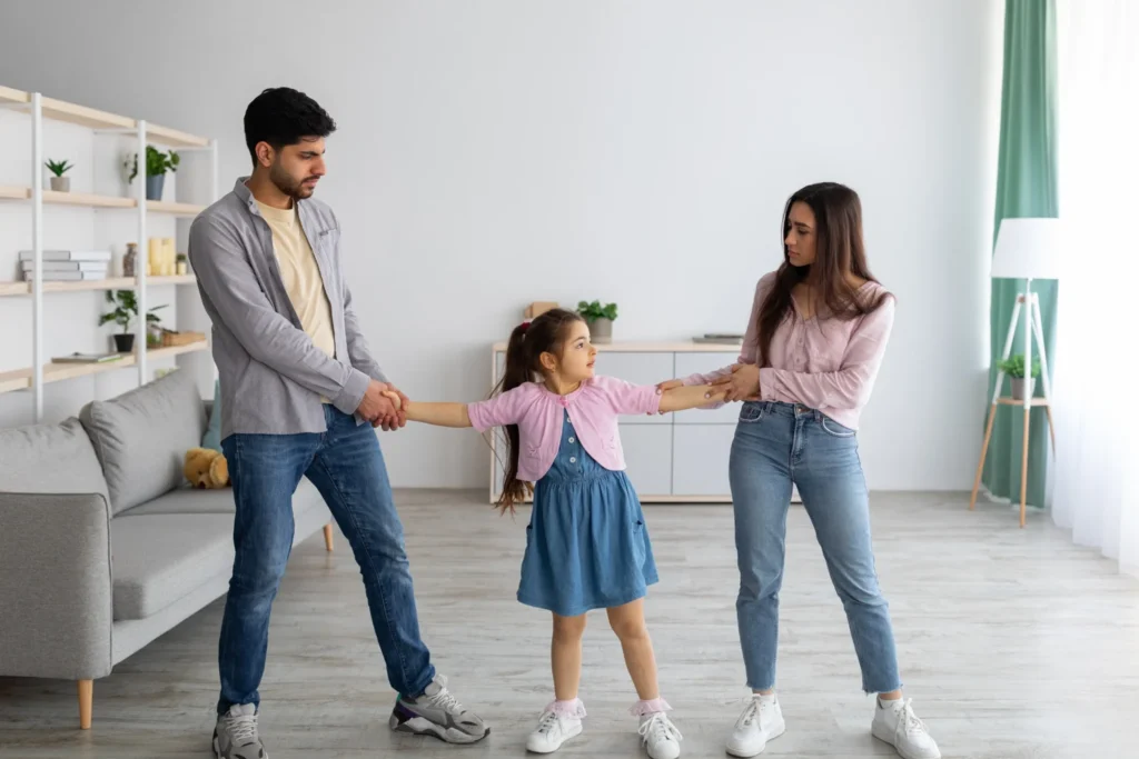 a man and woman holding hands with a girl