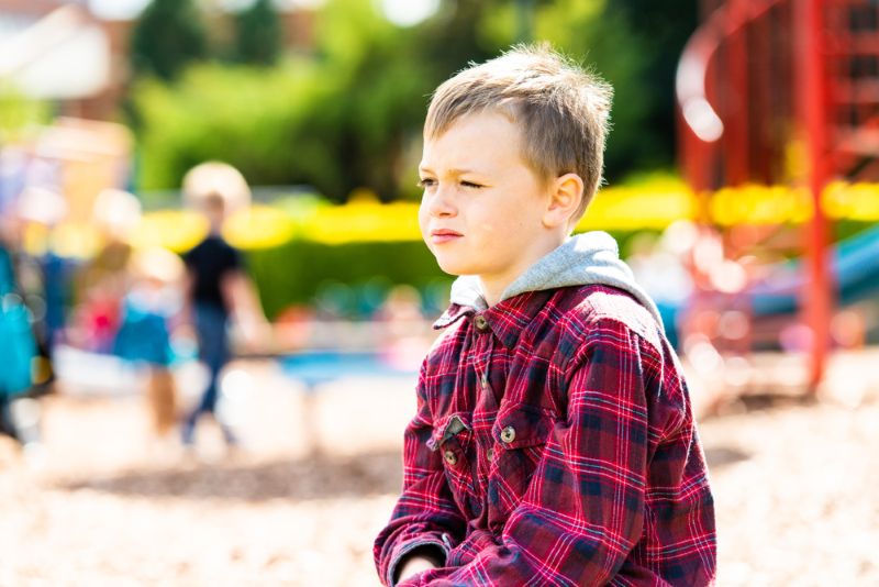 young boy by himself on the playground