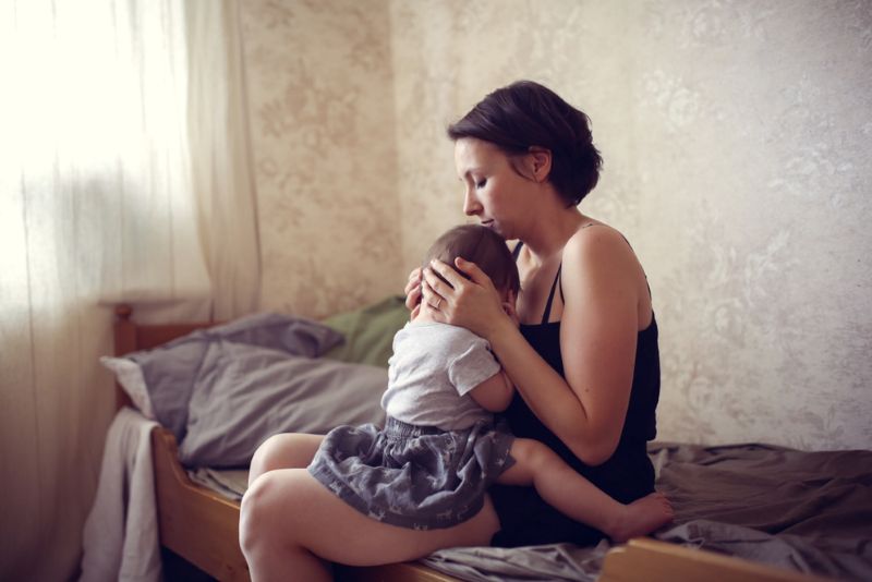 a young mother taking care of her newborn baby