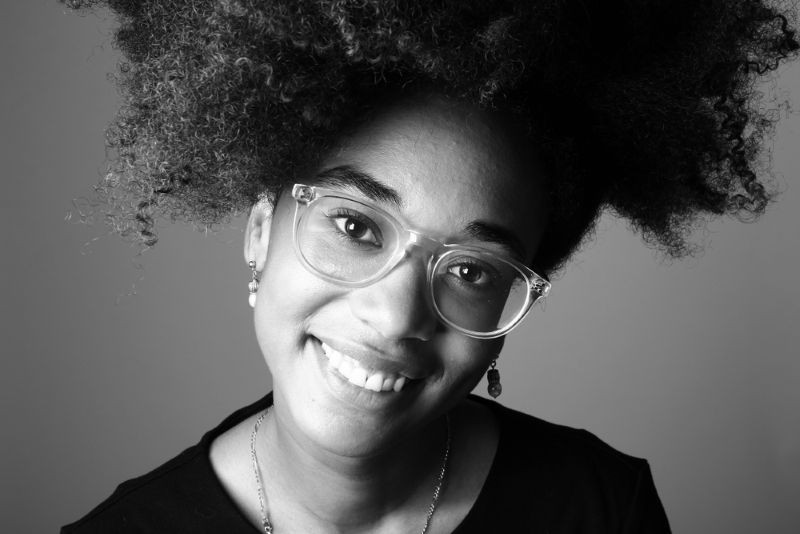 smiling young black woman wearing glasses