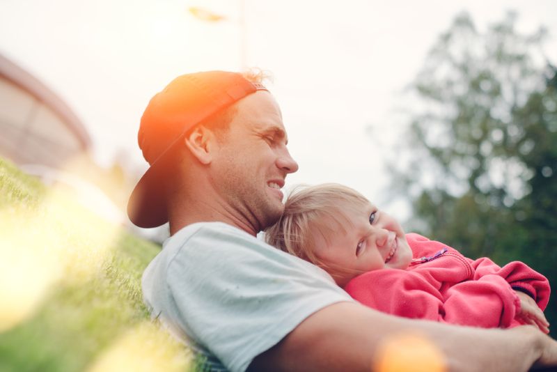 Father and daughter sitting outside together in the evening