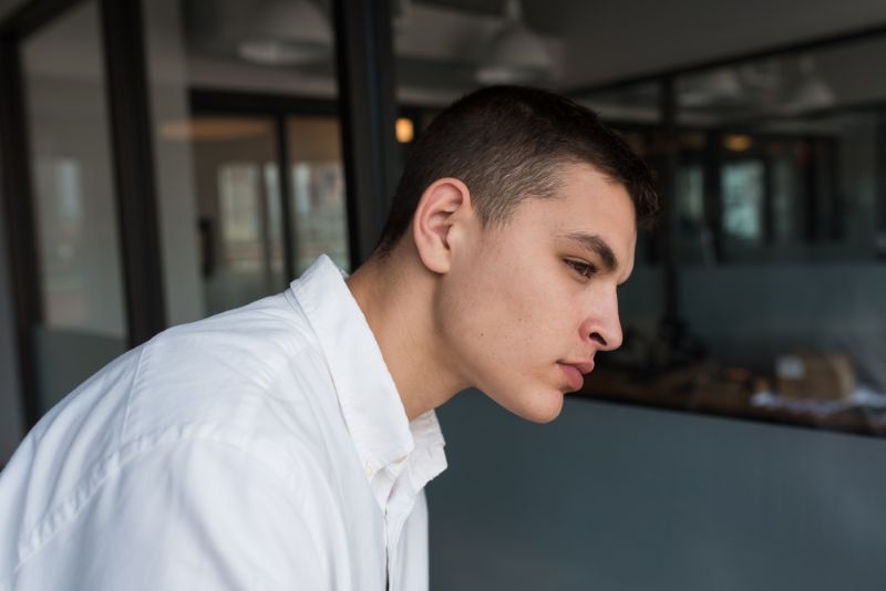 Young man sitting and thinking to himself