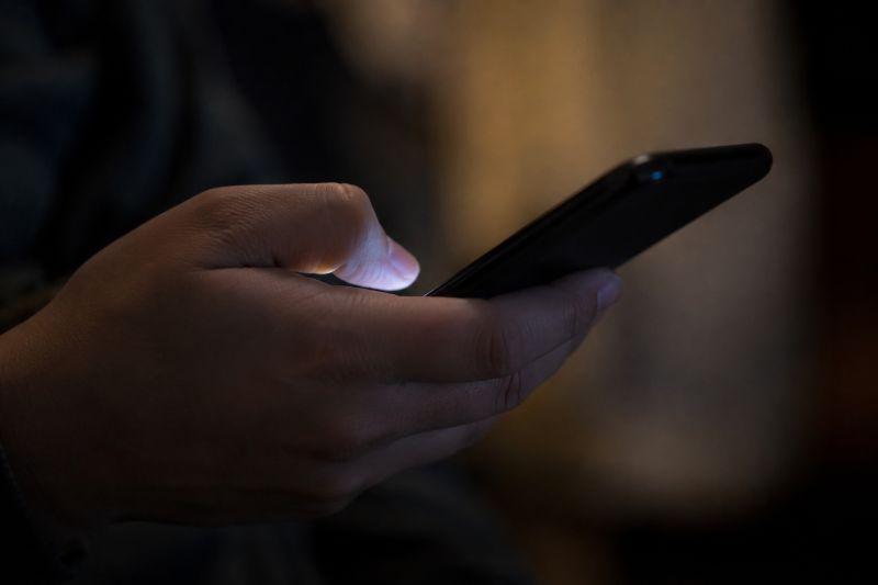 Closeup image of a person scrolling through social media