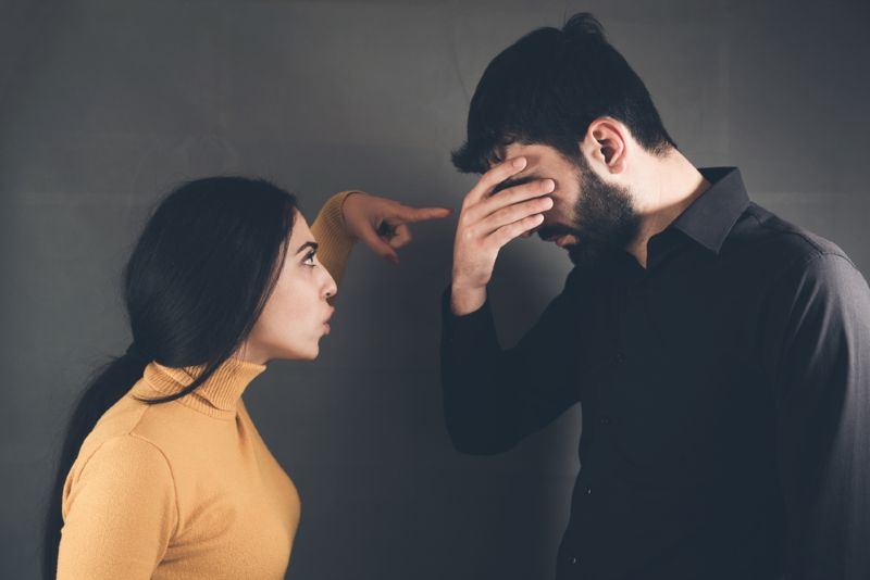 Angry woman yelling at disappointed husband